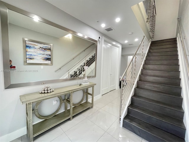 stairs with recessed lighting, visible vents, baseboards, and tile patterned floors