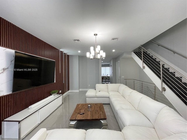 living area with visible vents, an accent wall, stairs, a chandelier, and recessed lighting