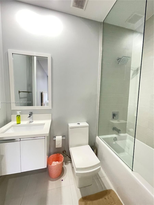 full bathroom featuring toilet, vanity, visible vents, shower / washtub combination, and tile patterned floors