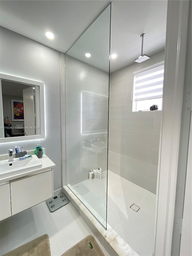 full bathroom featuring recessed lighting, vanity, and a walk in shower