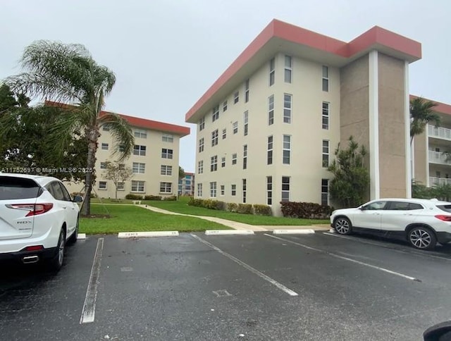 view of building exterior featuring uncovered parking