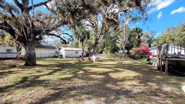 260 Fraser Ave, La Belle, FL 33935 - view of yard with a fenced backyard, an outdoor structure, and a storage shed