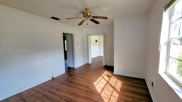 260 Fraser Ave, La Belle, FL 33935 - unfurnished room with dark wood-type flooring, a ceiling fan, visible vents, and baseboards