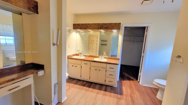 260 Fraser Ave, La Belle, FL 33935 - bathroom featuring toilet, double vanity, a sink, and wood finished floors