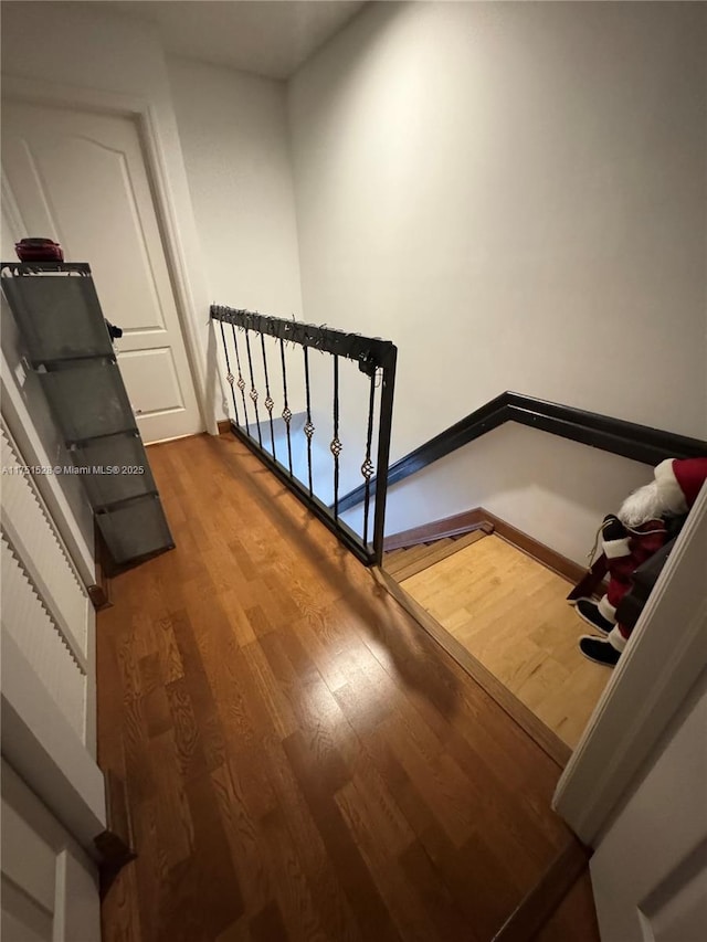 stairs with baseboards and wood finished floors