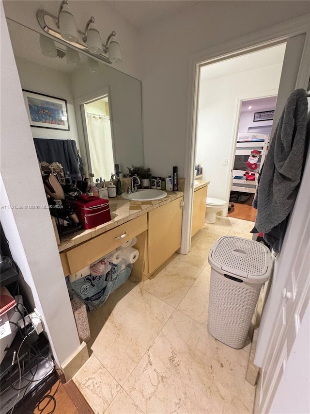 full bathroom with toilet and vanity