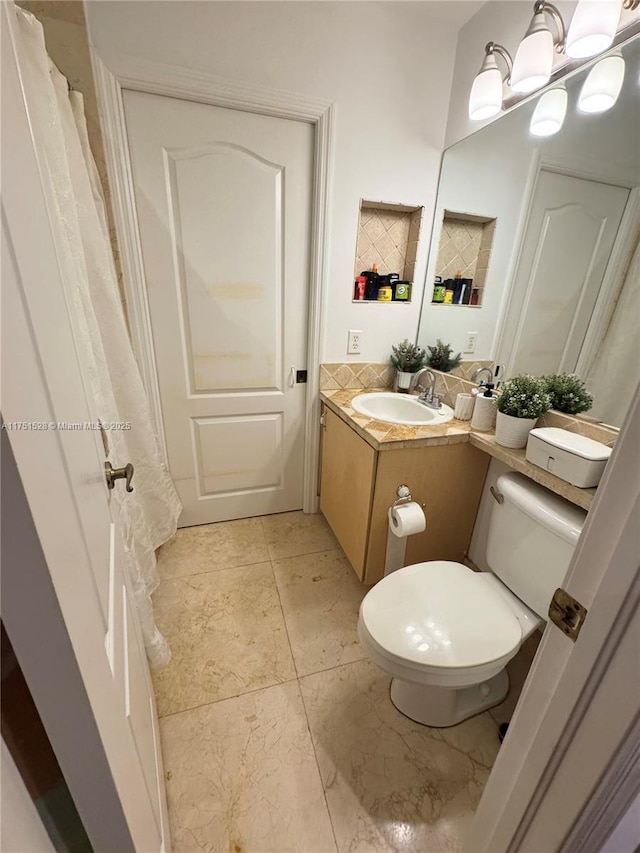 full bath featuring vanity, toilet, and tile patterned floors