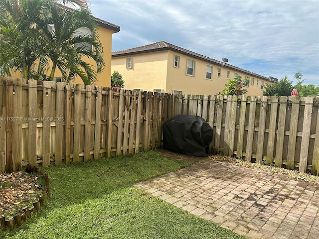 view of yard featuring a patio and a fenced backyard