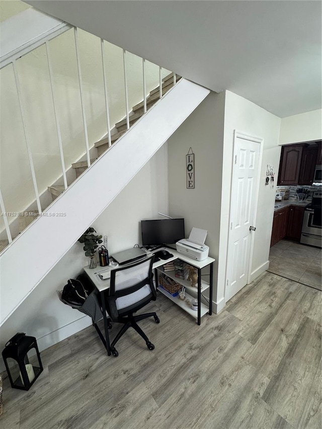 office area with light wood-style floors and baseboards
