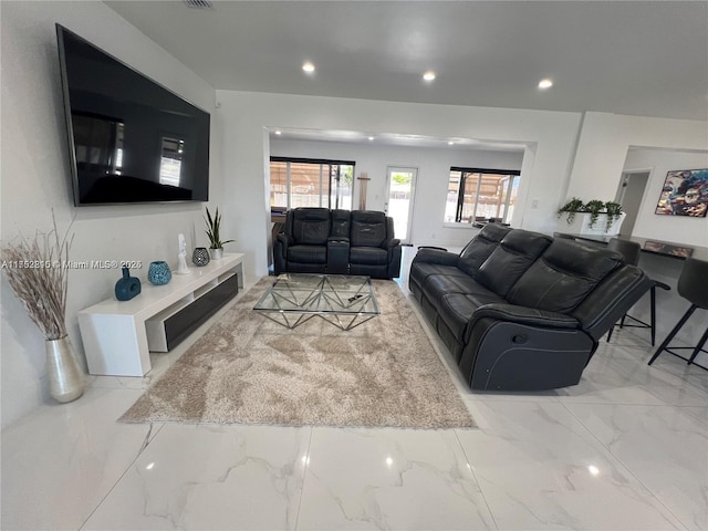 living room featuring marble finish floor, visible vents, and recessed lighting