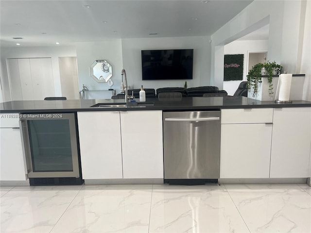 kitchen featuring wine cooler, a sink, white cabinetry, open floor plan, and dishwasher