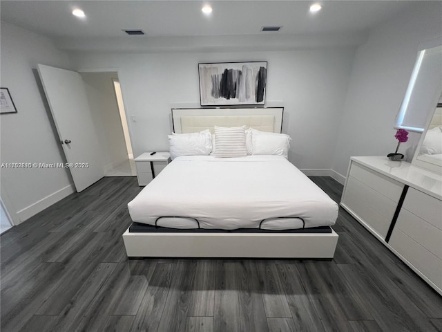 bedroom with baseboards, visible vents, dark wood finished floors, and recessed lighting