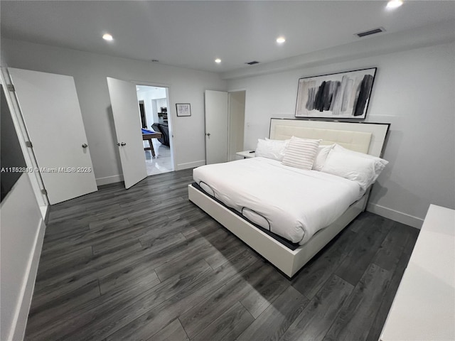 bedroom featuring baseboards, dark wood finished floors, visible vents, and recessed lighting