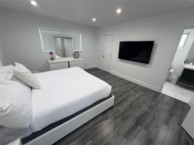 bedroom featuring dark wood-style floors, baseboards, connected bathroom, and recessed lighting