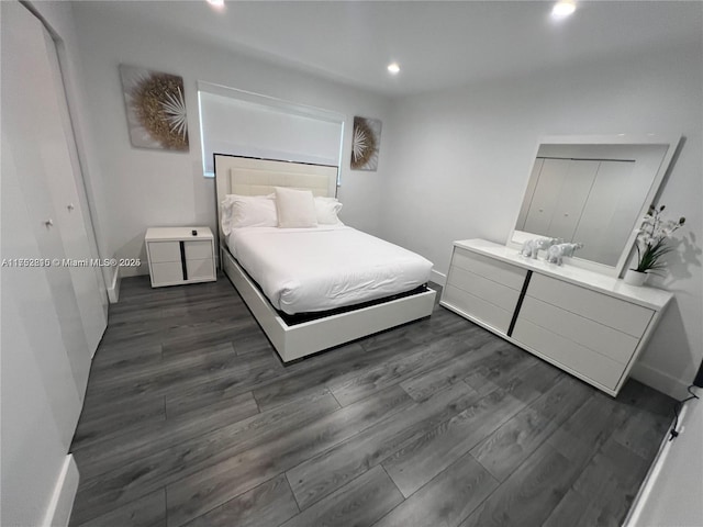 bedroom with dark wood-style floors and recessed lighting