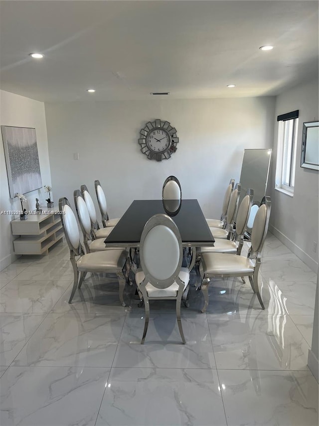 dining space with marble finish floor, baseboards, and recessed lighting