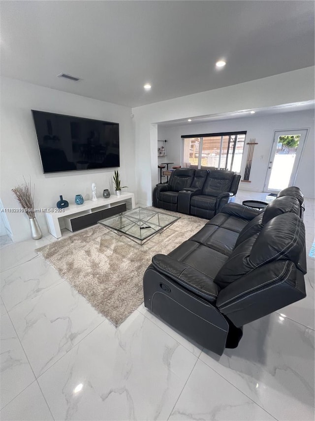 living room with marble finish floor, visible vents, and recessed lighting