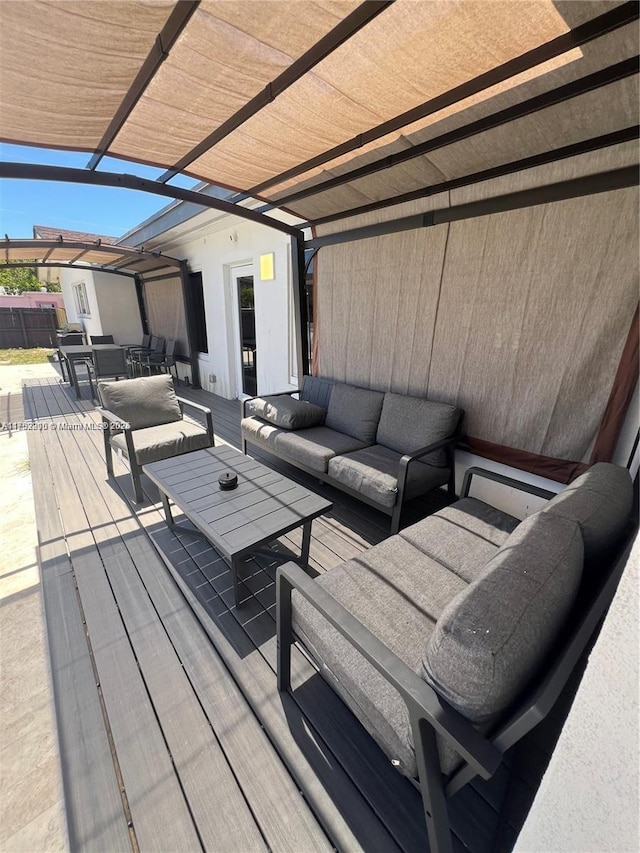 wooden deck featuring outdoor dining area, outdoor lounge area, and a pergola