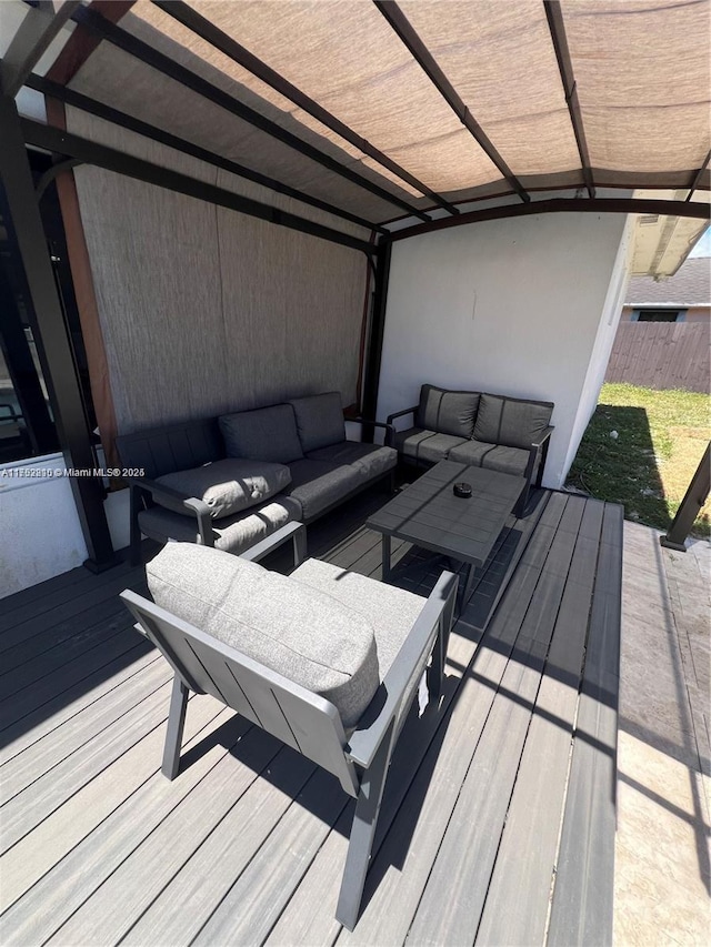 wooden deck featuring fence and an outdoor living space