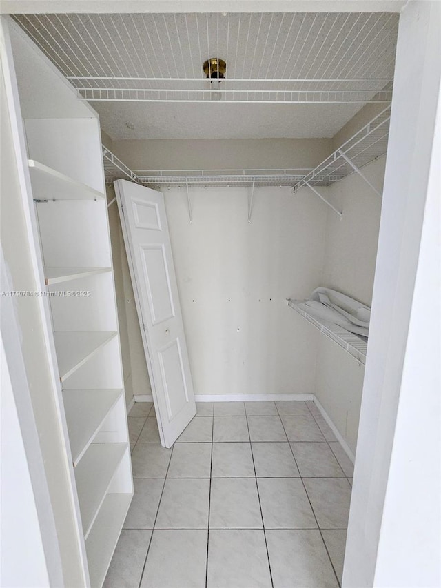 spacious closet featuring light tile patterned floors