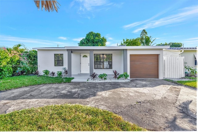 view of front of property with a garage, driveway, and stucco siding