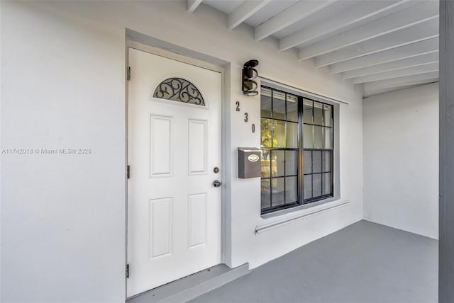 entrance to property with stucco siding