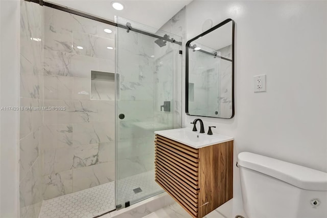 full bath with a marble finish shower, vanity, and toilet