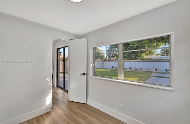 empty room with light wood-style floors and baseboards