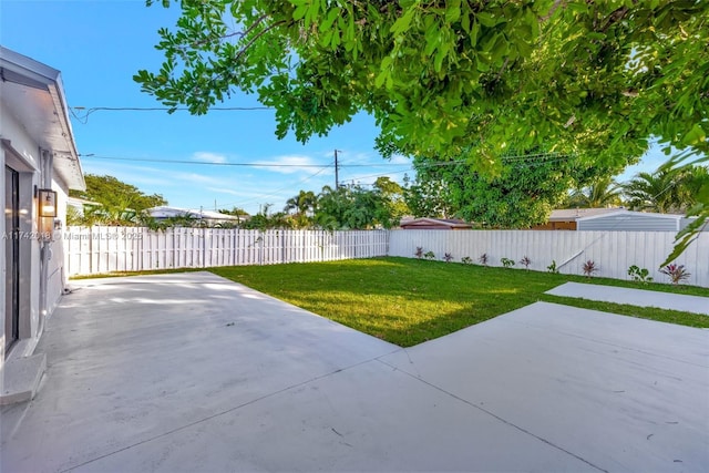 view of yard with a fenced backyard and a patio