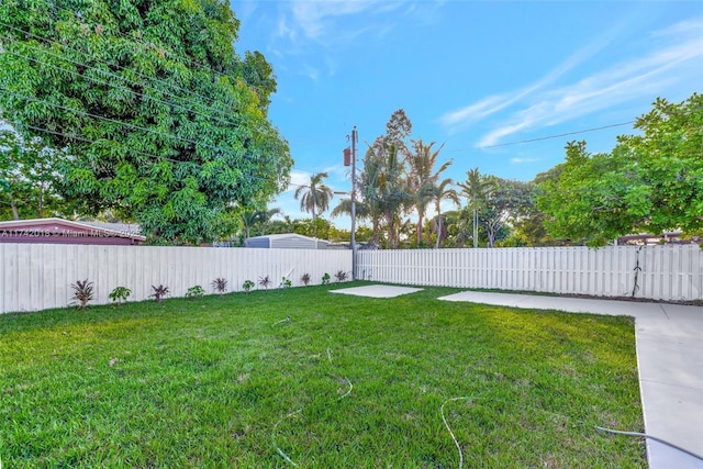 view of yard featuring a patio area and a fenced backyard