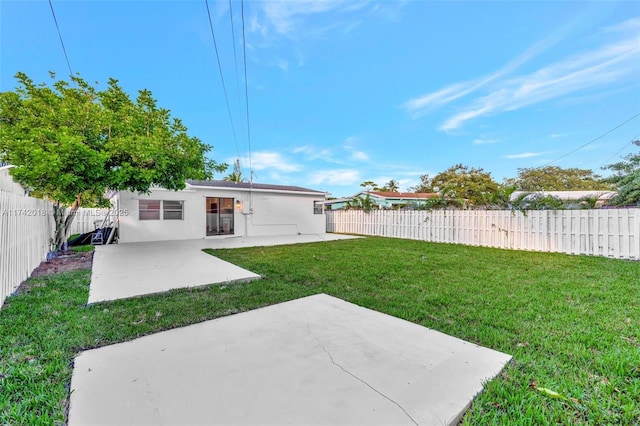 view of yard with a patio area and a fenced backyard