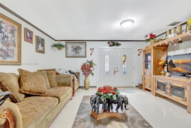 living area featuring ornamental molding, light tile patterned flooring, and visible vents