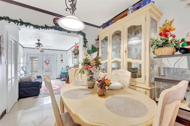 dining room with ornamental molding, french doors, and light tile patterned floors