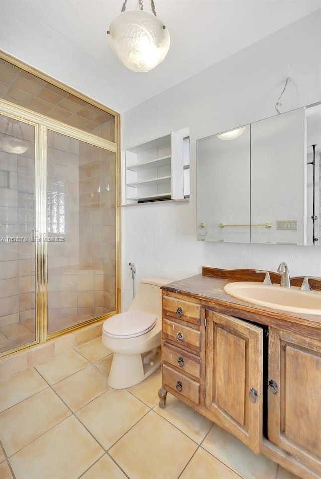 full bathroom with toilet, vanity, a shower stall, and tile patterned floors