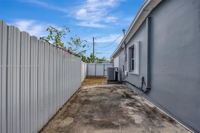 exterior space with a patio area, fence, and central air condition unit