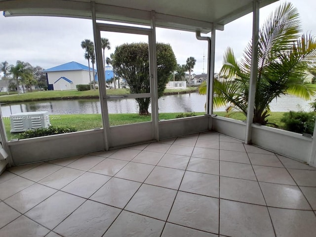 unfurnished sunroom with a water view