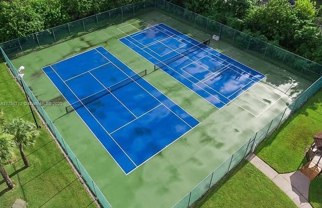 1860 Waterford Dr Unit 253, Vero Beach, FL 32966 - view of tennis court with fence and a lawn