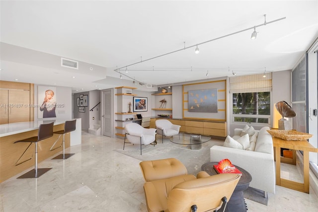 living room featuring stairs, visible vents, and track lighting