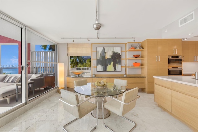 dining area with marble finish floor, visible vents, and track lighting