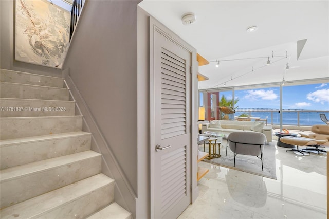 stairs featuring floor to ceiling windows