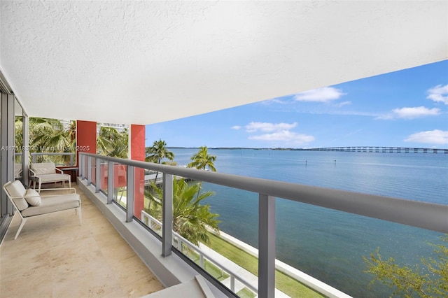 balcony featuring a water view