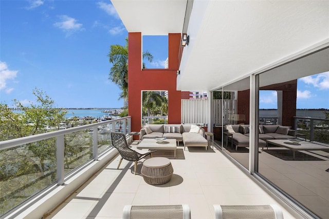 balcony with a water view and an outdoor living space