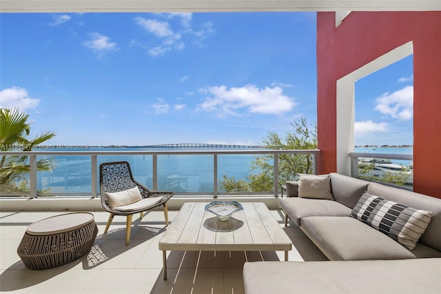 balcony with a water view and an outdoor hangout area