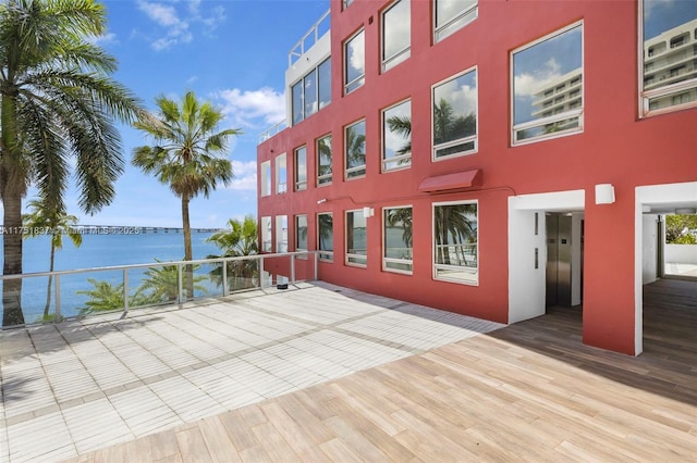 view of building exterior with elevator and a water view