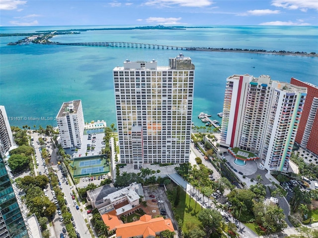 birds eye view of property with a water view and a view of city