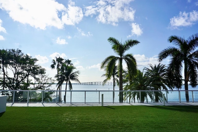 view of property's community featuring a yard and a water view