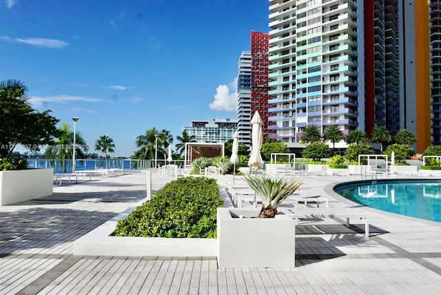 pool with a patio area and fence