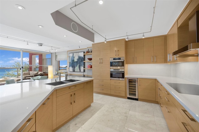 kitchen with beverage cooler, stainless steel double oven, wall chimney range hood, open shelves, and a sink