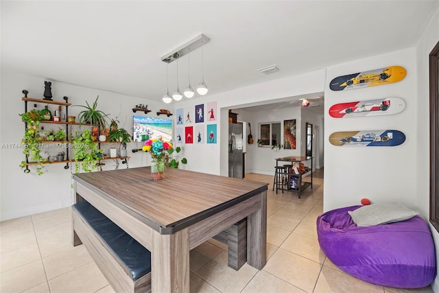 5801 NE 3rd Ave, Oakland Park, FL 33334 - dining area featuring light tile patterned floors and baseboards
