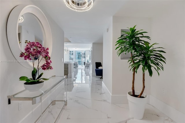 hall with marble finish floor and baseboards